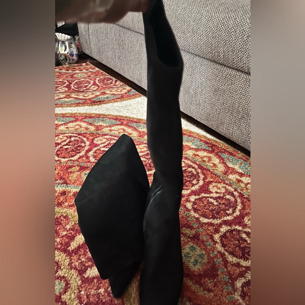 Black knee boots worn around the house